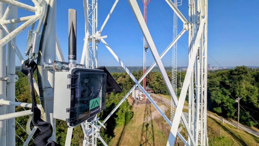 The Calvary node pictured in it's final mounted position. Nearby antenna structures, and the Pittsburgh skyline in the background.